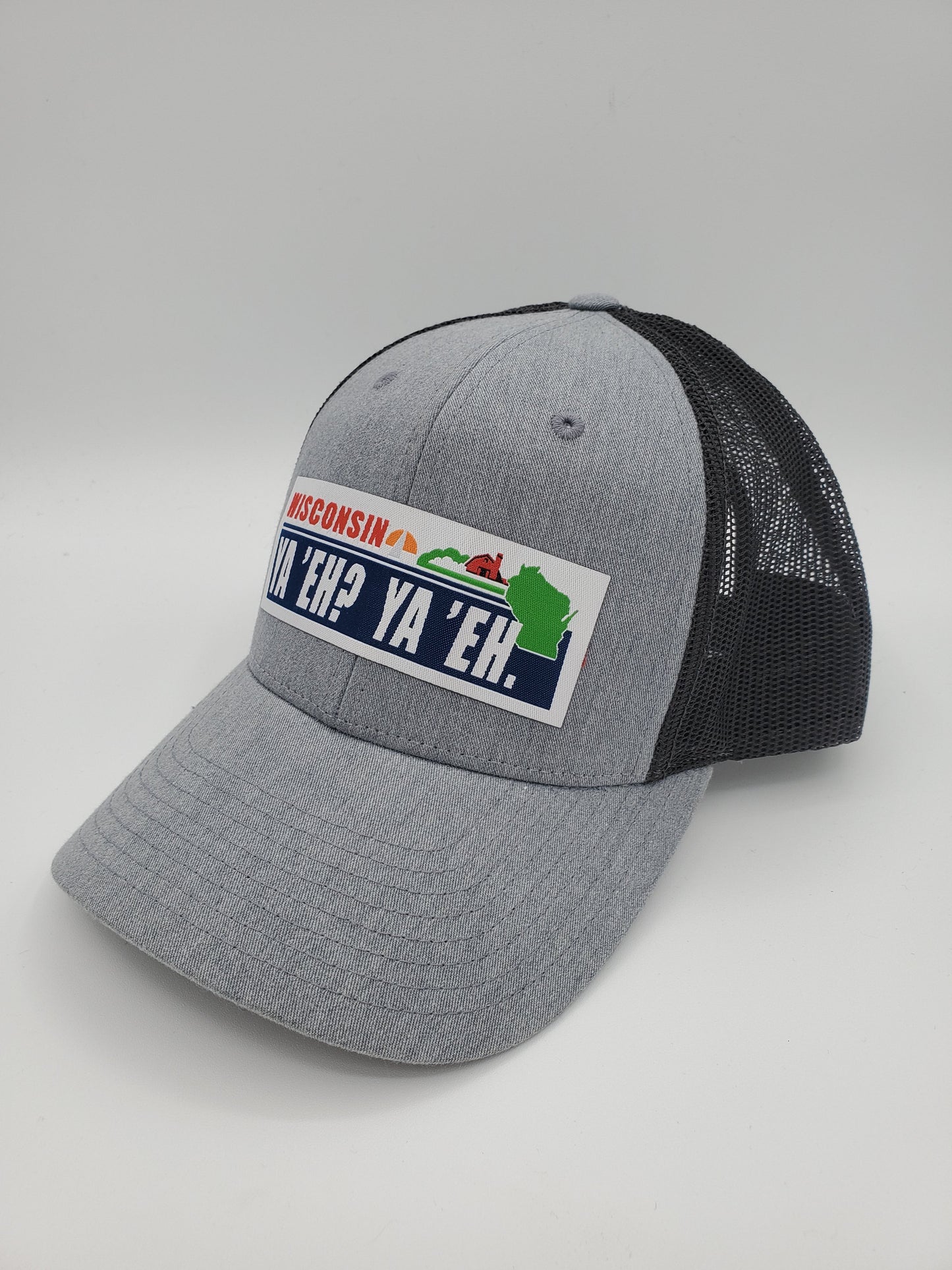 "Ya 'Eh? Ya 'Eh." Wisconsin Plate Design Trucker Hat (Black Mesh/ Heather Grey Fabric)